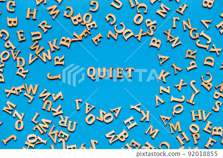 Word QUIET made out of wooden letters on bright blue background. Motivational Words Quotes Concept. 92018855