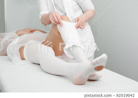 Anti-embolic Compression Hosiery for surgery isolated on white. Medical white stockings, tights for varicose veins and venouse therapy. Thrombo embolic deterrent hose or anti-embolism stockings. 92019042