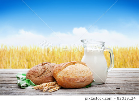 Homemade bread and milk on wooden table Homemade bread and milk on wooden table 92019124