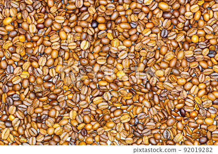 Coffee beans. Background of roasted fresh brown coffee beans. Perfect for a cool wallpaper. Banner for cafe. Template for cafe menu.  Copy space. Beautiful closeup shot of fresh black coffee beans 92019282