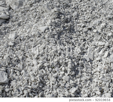 Natural chalk mineral background. Small smooth calcite stones are mixed with chalk clay. Calcium in nature. Natural white chalk texture 92019658