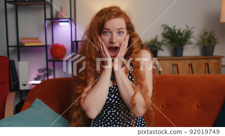 Excited young woman surprised, shocked by sudden victory, good win news, celebrating, wow reaction Excited young woman surprised, shocked by sudden victory, good win news, celebrating, wow reaction 92019749