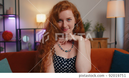 Close-up of happy beautiful teenager redhead freckles woman smiling looking at camera at home Close-up of happy beautiful teenager redhead freckles woman smiling looking at camera at home 92019751