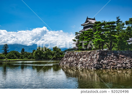Matsumoto Castle (Summer sunny castle moat pine forest stone wall blue sky cloud) Matsumoto Castle (Summer sunny castle moat pine forest stone wall blue sky cloud) 92020496