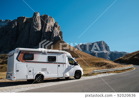 VR Caravan family car on vocation in Dolomites Alps with rocky mountains on a background . Beautiful nature in early autumn season. VR Caravan family car on vocation in Dolomites Alps with rocky mountains on a background . Beautiful nature in early autumn season. 92020636