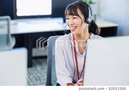 A woman working at a call center A woman working at a call center 92023308