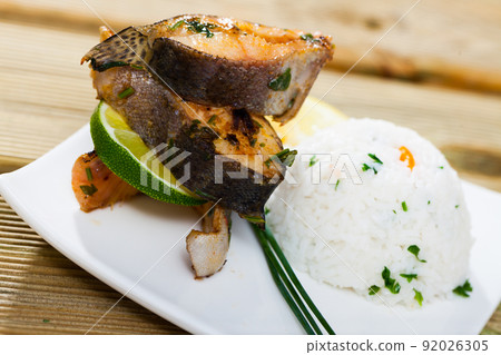 Baked trout steaks with rice Baked trout steaks with rice 92026305