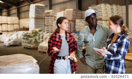 International team of workers checking order list International team of workers checking order list 92026471
