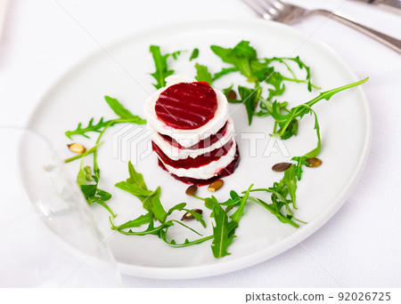 Fresh beetroot and goat cheese salad served on plate 92026725