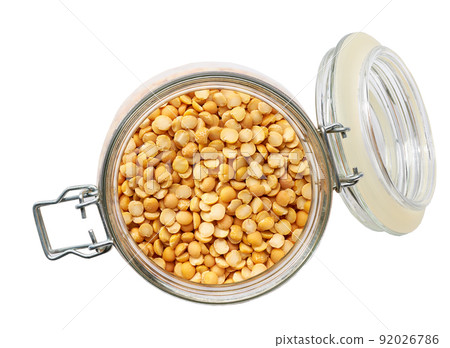 Heap of uncooked dried peas grains in glass storage jar isolated on white background top view. Heap of uncooked dried peas grains in glass storage jar isolated on white background top view. 92026786