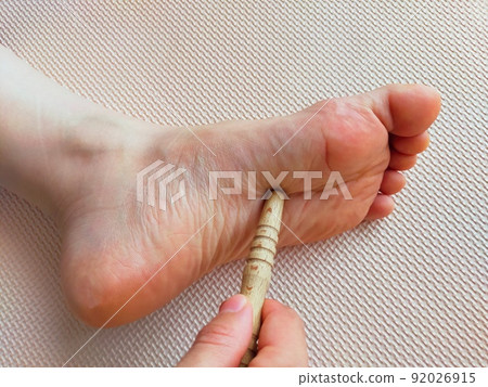 Foot pressure point massage with acupressure stick_Healthy image 92026915