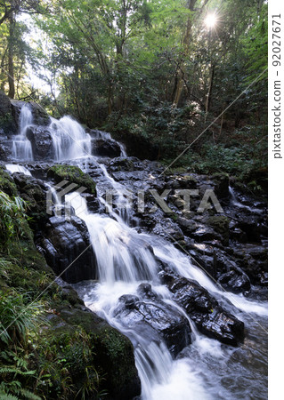 Nanatsu Falls flowing down in the bright green 92027671