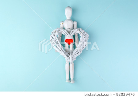 Love and Valentines Day concept. Wooden mannequin with a red heart. 92029476