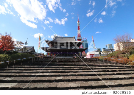 From the bottom of the stairs in front of Tokyo Tower and Zoujoji Temple on a sunny day 92029556