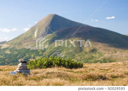 Stack of zen stones overlooking the top of mountain. Concept of balance and harmony. Stack of zen stones overlooking the top of mountain. Concept of balance and harmony. 92029593
