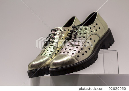 Pair of fashionable new comfortable leather light white sport running shoes sneakers isolated on copy space market counter background. Style, design and fashion, modern footwear. 92029960