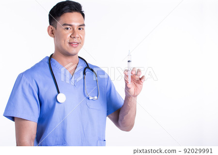Asian male doctor wearing uniform and using syringe for virus protection Asian male doctor wearing uniform and using syringe for virus protection 92029991
