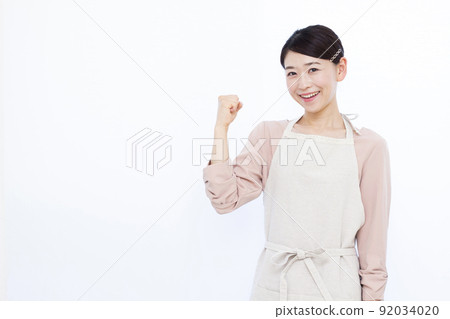 Housewife in her thirties doing a guts pose Housewife in her thirties doing a guts pose 92034020