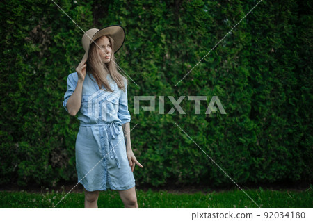 Romantic girl with hat on picnic in park Romantic girl with hat on picnic in park 92034180