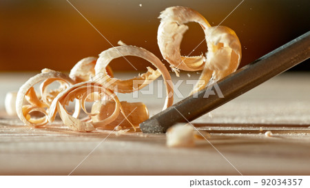 Macro shot of chisel cutting the spruce plank. Macro shot of chisel cutting the spruce plank. 92034357