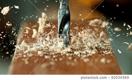 Drilling wooden plank, close-up. 92034369