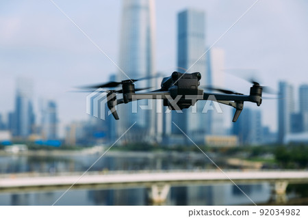 Flying drone in modern city 92034982