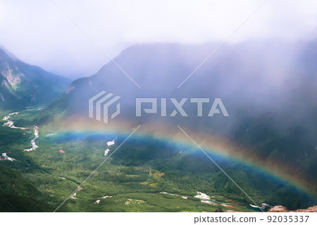 A rainbow over the valley 92035337