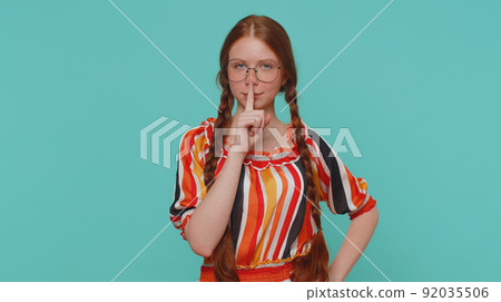Girl presses index finger to lips makes silence gesture sign do not tells secret, shh be quiet Girl presses index finger to lips makes silence gesture sign do not tells secret, shh be quiet 92035506