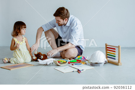 Father and son playing together at home Father and son playing together at home 92036112