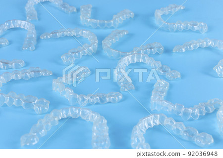 Invisalign transparent brackets or braces on blue background 92036948