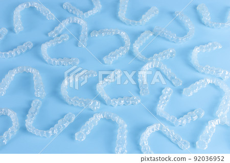 Invisalign transparent braces or brackets on blue background 92036952