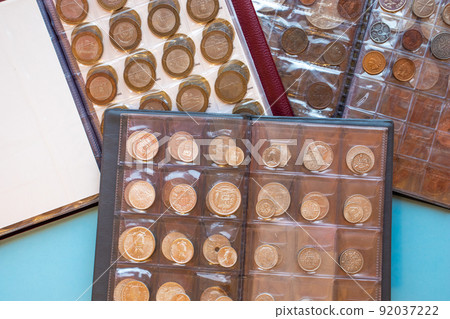 Three plastic transparent coin albums as a hobby concept. Collecting coins, numismatism Three plastic transparent coin albums as a hobby concept. Collecting coins, numismatism 92037222