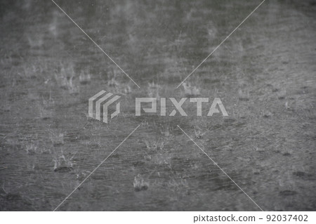 Rain hitting the asphalt 92037402