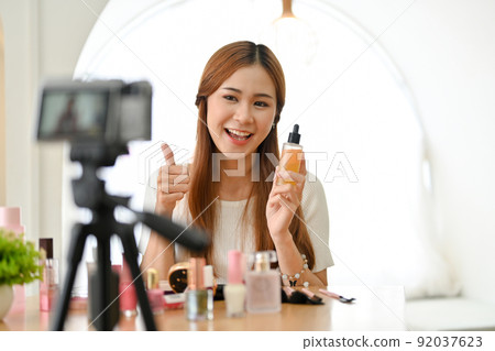 Attractive young Asian female freelance beauty blogger reviewing her cosmetic Attractive young Asian female freelance beauty blogger reviewing her cosmetic 92037623