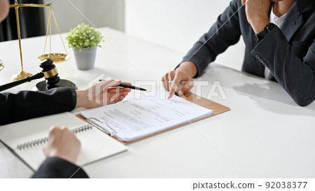 A professional male lawyer has a meeting with a client to provide counseling and give advice A professional male lawyer has a meeting with a client to provide counseling and give advice 92038377