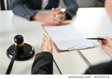 A professional female lawyer is having a meeting with her client to give legal advice A professional female lawyer is having a meeting with her client to give legal advice 92038378