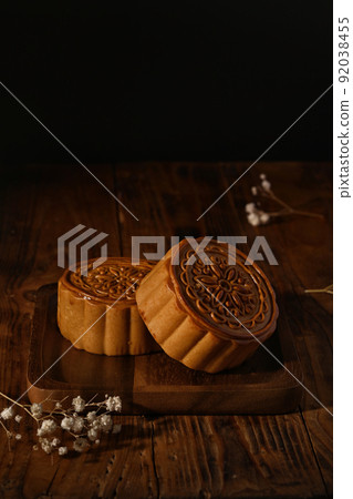 Traditional moon cakes on wooden tray, for Mid Autumn festival. Concept of Chinese traditional food and dessert Traditional moon cakes on wooden tray, for Mid Autumn festival. Concept of Chinese traditional food and dessert 92038455