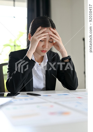 Stressed and exhausted Asian businesswoman pensive thinking a financial strategy Stressed and exhausted Asian businesswoman pensive thinking a financial strategy 92038457