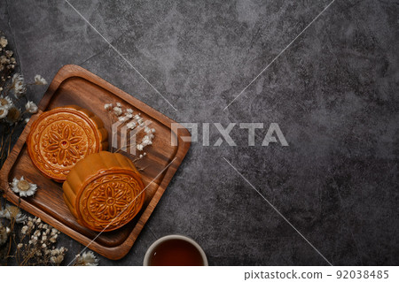 Above view Chinese moon cake for Mid Autumn festival and tea on rustic stone background with copy space 92038485