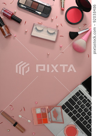 Top view laptop, makeup brushes and cosmetics on pink background. Feminine workspace Top view laptop, makeup brushes and cosmetics on pink background. Feminine workspace 92038486