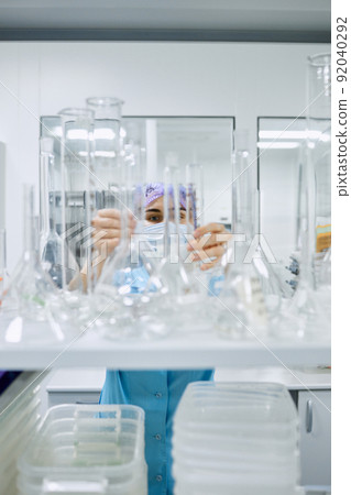 A girl scientist checks a sample for research A girl scientist checks a sample for research 92040292