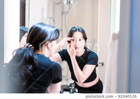 A young woman wearing a contact lens 92040526