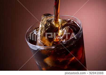 Pour iced coffee into a glass 92041088