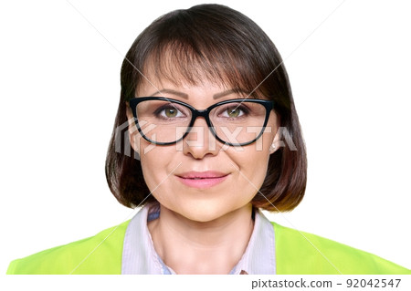 Headshot of industrial mature woman in protective vest glasses, on white isolated background Headshot of industrial mature woman in protective vest glasses, on white isolated background 92042547