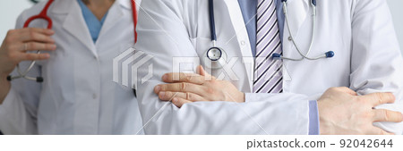 Medical workers in uniform with stethoscopes, medical help, emergency team, qualified doctor and nurse Medical workers in uniform with stethoscopes, medical help, emergency team, qualified doctor and nurse 92042644