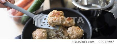 Tasty aromatic meat balls frying in oil on pan on kitchen stove 92042662