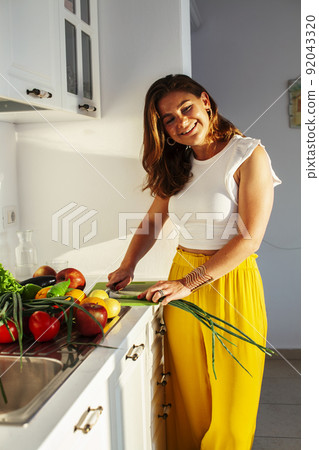 real cheerful lady on kitchen preparing dinner, lifestyle people concept close up real cheerful lady on kitchen preparing dinner, lifestyle people concept close up 92043320