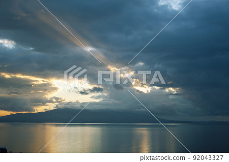 beautiful landscape on sea with sunset, dramatic clouds with red fire close up 92043327