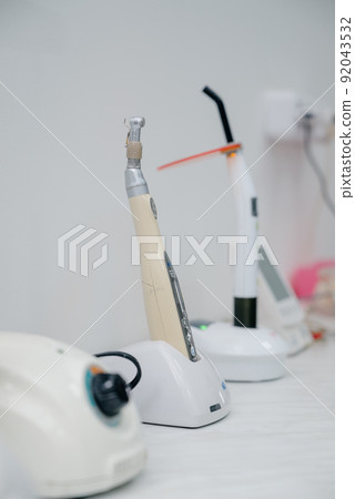 Interior of the office of patients reception with dental equipment in the dental clinic.Interior of dental practice room with chair, lamp, display and stomatological tools 92043532