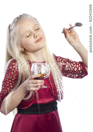 Beautiful blonde girl eating dessert 92043806
